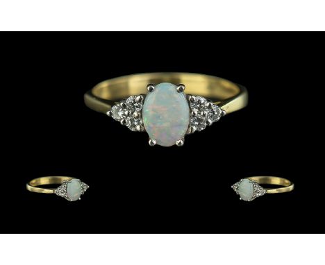 18ct Gold - Petite Opal and Diamond Set Ring of Elegant Form. Full Hallmark for 18ct. The Oval Shaped Opal of Pleasing Colour