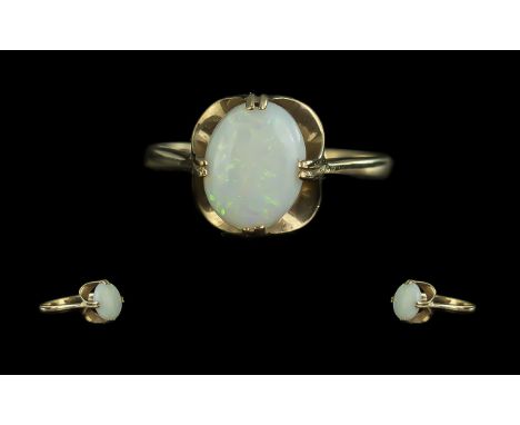 Opal Solitaire Ring, an attractive opal of good colour set in 9ct gold; ring size M, fully hallmarked for gold, 1.9g