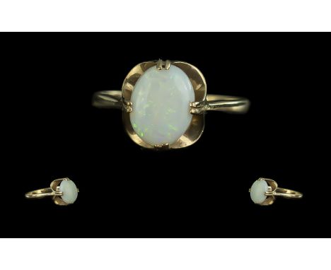 Opal Solitaire Ring, an attractive opal of good colour set in 9ct gold; ring size M, fully hallmarked for gold, 1.9g