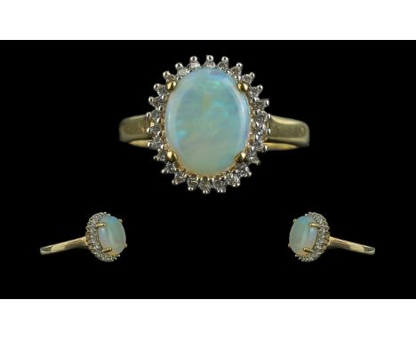 Ladies 9ct Gold Attractive Opal and Diamond Set Cluster Ring. Marked 9ct to Interior of Shank. The Large Cabochon Cut Opal Su