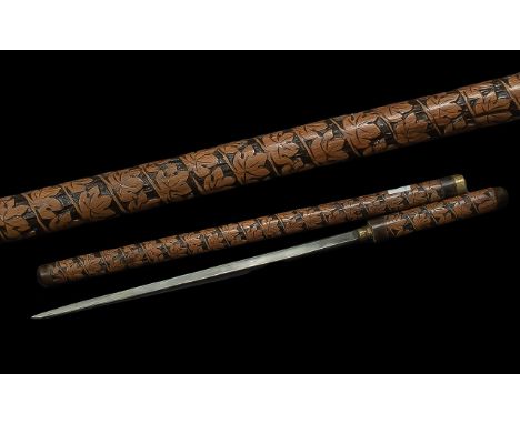 Early 20th Century Sword Stick / Baton with highly carved decoration and brass mount; 21 inches (52.5cms) long