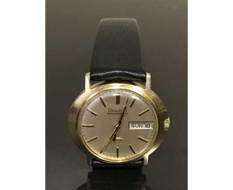 A scarce 9ct gold Bulova Accuquartz wristwatch with Day-Date indication, silvered dial with centre seconds and baton numerals