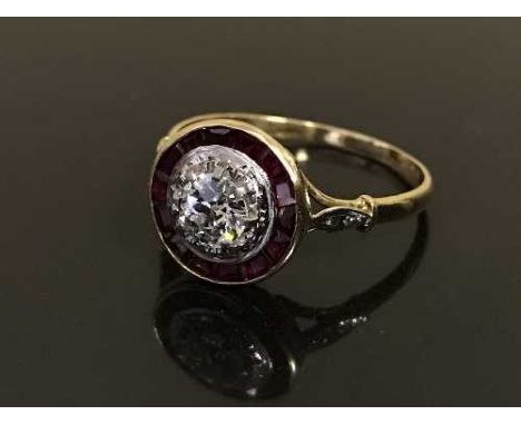 An Art Deco 18ct gold diamond and ruby set cluster ring