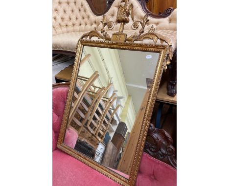 A wall mirror, with an eagle finial, 75 cm wide