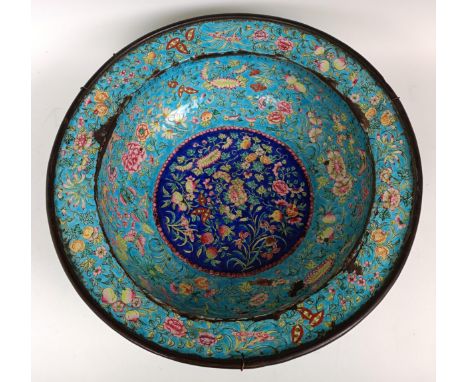 A Chinese enamel bowl, decorated flowers and butterflies, various losses, 42 cm diameter