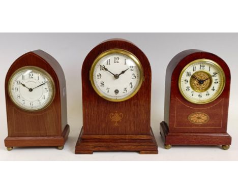 An Edwardian mantel clock, in an inlaid mahogany case, 21.5 cm high, and two others similar (3)