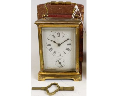 A carriage clock, with alarum, the enamel dial in a brass case, 15 cm high, in a leather travelling case