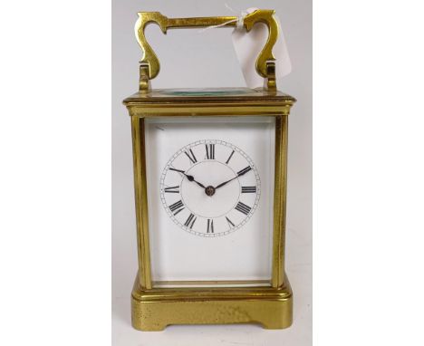 A carriage timepiece, the 6.5 cm wide enamel dial with Roman numerals, in a brass four pillar case, 18 cm high
