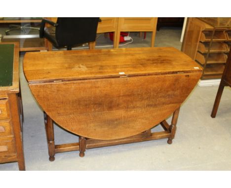 Reproduction oak gate-leg table with drawer