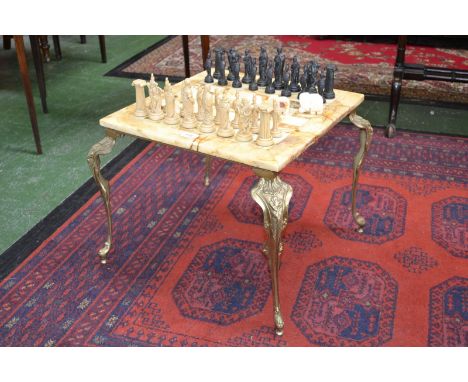 An Onyx chess set table and chess pieces