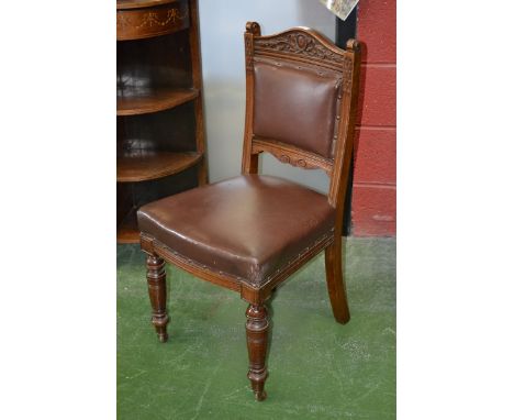 An Edwardian mahogany hall chair, shaped and carved top rail, scrolling terminal to fluted uprights, padded back and seat, tu