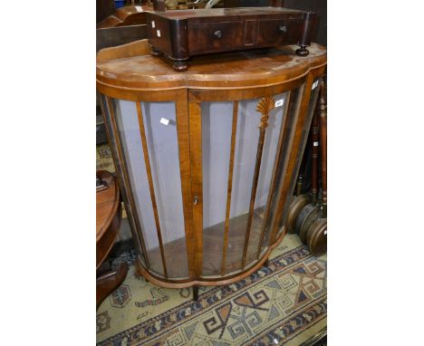 A 1930s walnut bow fronted glazed display cabinet