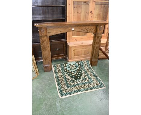 An oak fire surround; a carpet in tones of green and cream (2)