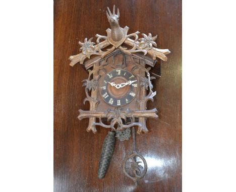 A late 19th century Black Forest cuckoo clock, by Camerer, Cuss & Co, 13.5cm circular dial applied with Roman numerals, strik