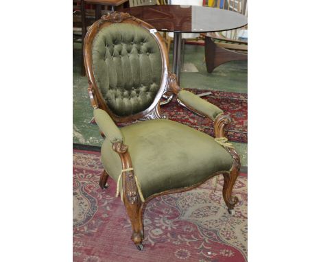 A Victorian walnut spoon back armchair, outswept arms, stuffed over upholstery, carved throughout with acanthus scrolls, cabr
