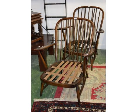 A pair of Ercol open arm chairs.