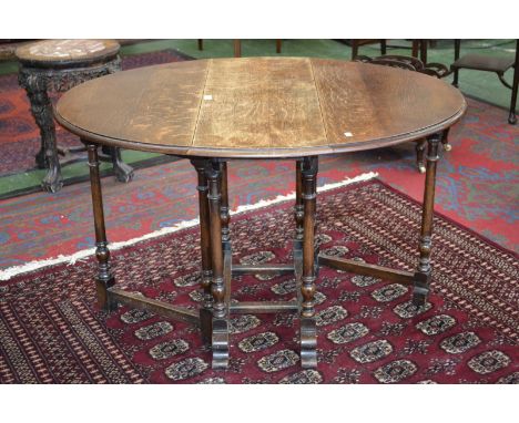 An early 20th century oak gate leg dining table