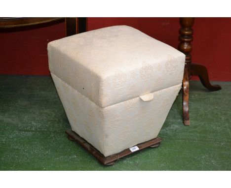 A Victorian pouffe, square hinged cover, tapering sides, bun feet. 44cm high x 41cm wide.