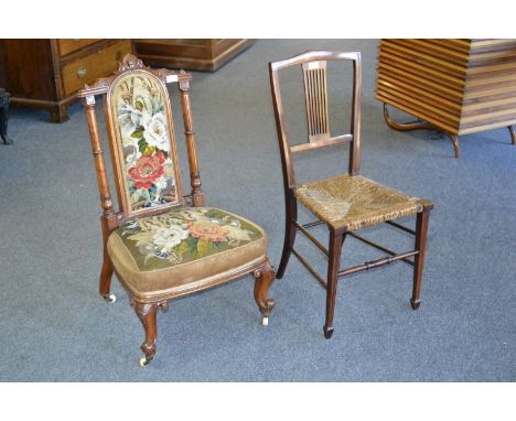 A Victorian mahogany nursing chair, carved turned supports with ceramic casters, circa 1880; an Edwardian mahogany and satinw