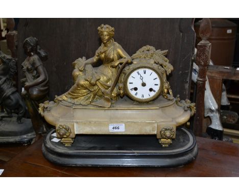 A late 19th century gilt brass mantel clock, mounted with a figure allegorical of harvest, shaped marble base, oval ebonised 