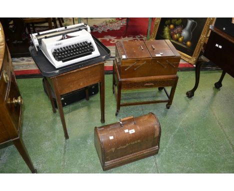 A 1950's oak sewing table/box; a 1950's work box; a mid 20th century oak cased Singer sewing machine; a cased typewriter. (4)