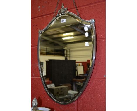 A chrome mounted shield shaped wall mirror, urnular finial