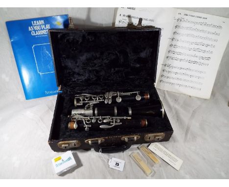 A Boosey & Hawkes of London clarinet, The Edgware, with hard case, reeds, sheet music, a the learn how to play the clarinet B
