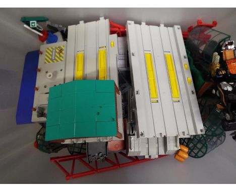 A plastic chest containing a large amount  of Thomas the Tank Engine train track, engine, trains, carriages  and accessories