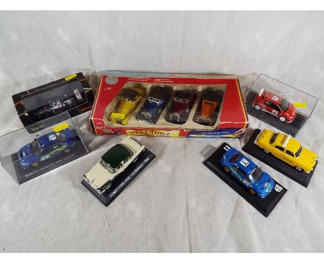 A collection of diecast model motor vehicles to include five model cars on plinths, an onyx model Indy car, boxed and a dieca