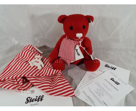 A Steiff Filzteddybar, red, issued in a limited edition (No 390), 25 cm (h) boxed with certificate of authenticity and other 