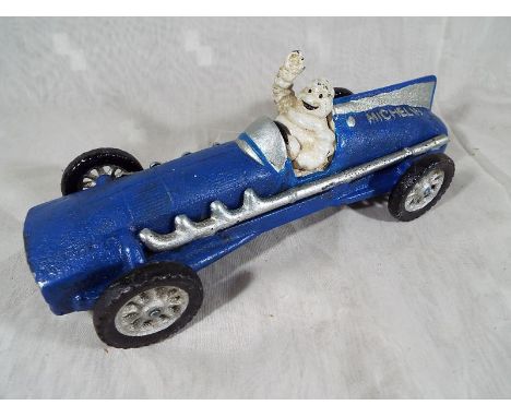 A cast iron novelty blue racing car in the form of a 1934 Hubley marked Michelin with a depiction of the Michelin man within,