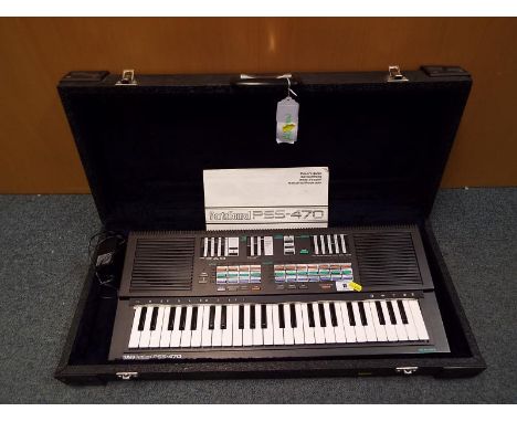 A Yamaha Porta Sound PSS-470 keyboard, with power supply manual and hard case - Est £20 - £30