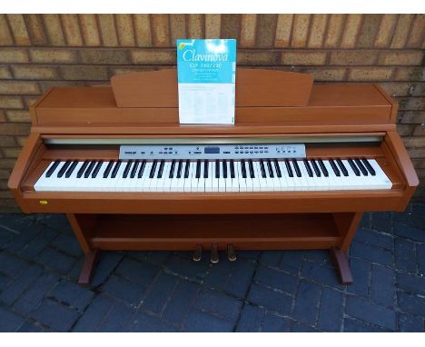 A Yamaha Clavinova CLP-230 piano with manual