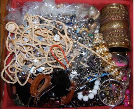 An early 20th century oak box and contents to include; costume jewellery, African style bangle, bead necklaces etc 