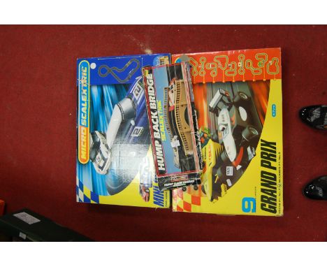 A boxed Micro Scalextric mini challenge together with one other similar and a boxed humped back bridge