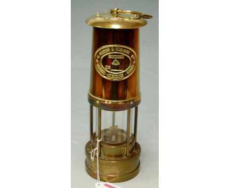 A reproduction brass miners safety lamp