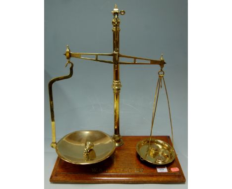 A Victorian brass balance scale and weights on a mahogany plinth by W & T Avery Ltd 