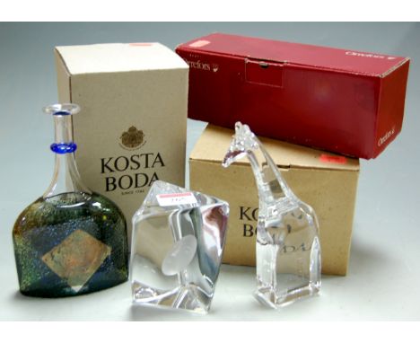 An Orrefors glass giraffe, signed and numbered verso, and two Costa Boda glass ornaments to include triform desk-weight, all 