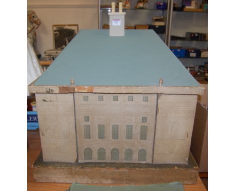 An early 19th century wooden dolls house with painted paper lithograph frontage and interior having replacement roof all rais