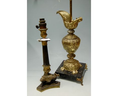 A gilt metal table lamp in the form of a classical ewer of a marble plinth, together with a Rococo style lamp base (2) 