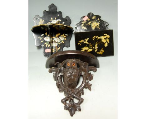 A carved softwood wall bracket in the form of an owl; together with a black lacquered wall pocket and folding shelf (3) 
