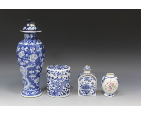 A Chinese famille rose and underglaze blue tea caddy, early 19th Century, the ovoid body decorated with flowers, height appro