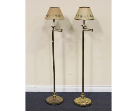 A pair of 20th Century gilt brass adjustable lamp standards, raised on circular bases, height approx 140cm.