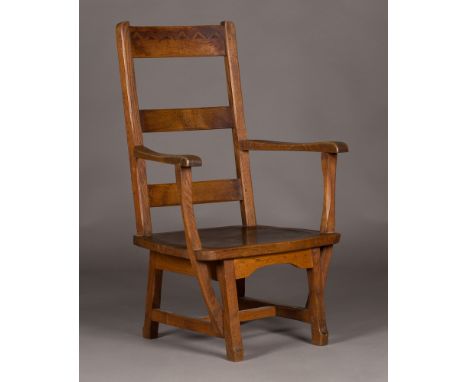An Arts and Crafts Cotswold School oak ladder back armchair, in the manner of Arthur Romney Green, the chamfered and carved b