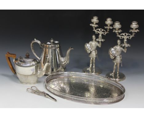 A small collection of plated items, including a pair of candelabra, each in the form of a medieval knight, a teapot of half-r