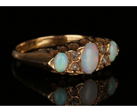 An 18ct gold, opal and diamond ring, mounted with three oval opals and two pairs of diamonds, Chester 1919, ring size approx 