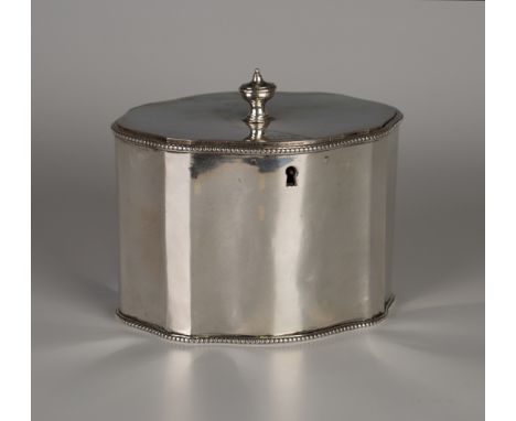 A George III silver tea caddy of serpentine outlined oval form, the hinged lid with urn shaped finial above beaded rims, Lond