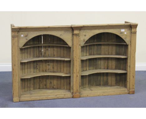 A 19th Century pine double barrel-back hanging wall shelf, fitted with a pair of arched shelf units flanked by fluted pilaste