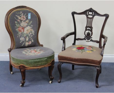 A late Victorian walnut salon chair with a carved flowerhead and leaf surmount, the seat and back upholstered in floral gros 