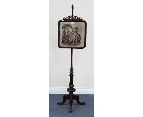 A Victorian rosewood pole screen, fitted with a glazed needlework panel, on a turned stem and tripod cabriole legs, height ap